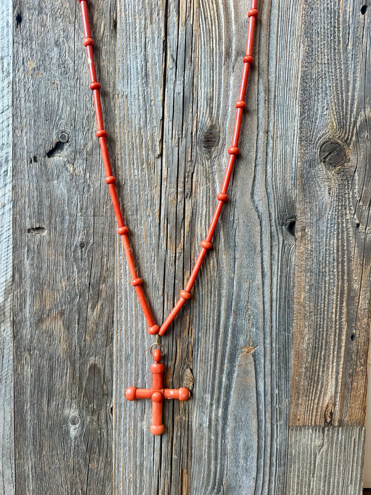 A sublime and rare antique coral (corallium rubrum) cross pendant necklace, circa late 18th century.